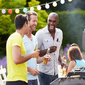 Stock photo: Guys grilling out and laughing