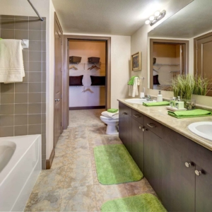 La Frontera Square 1 Bedroom Home bathroom with dual sink vanities, deep soaking tub and walk-in closet