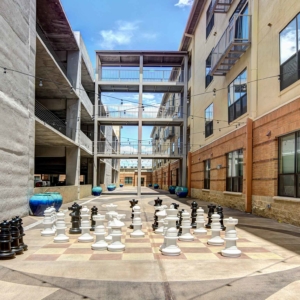 Daytime shot of courtyard featuring life-size chess game