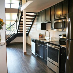 Loft Kitchen at la frontera square stainless steel appliances and stairs leading to loft