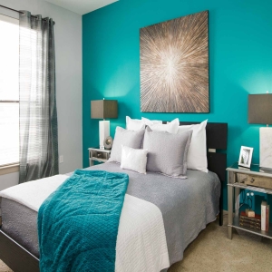 2 Bedroom Model Home Bedroom- Teel color scheme and modern furnishings